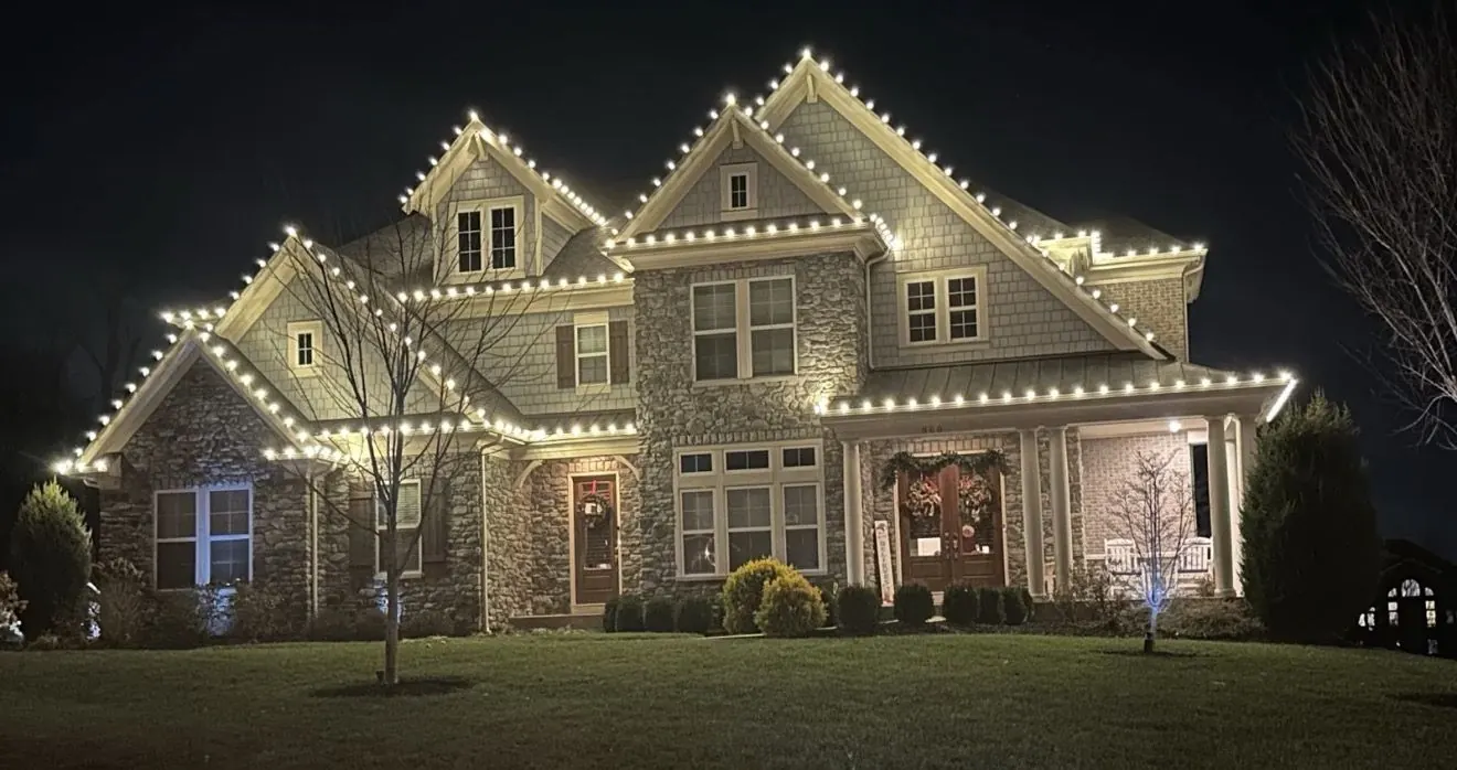 Roofline and gables outlined in warm white lights